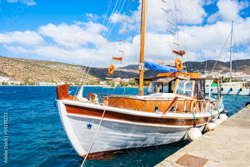 Obraz na płótnie Traditional fishing boat anchoring in small port of Katapola village, Amorgos island, Cyclades, Greece w salonie