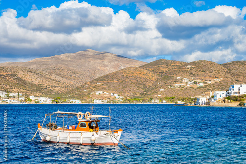 Obraz na płótnie Traditional fishing boat anchoring in Katapola sea bay and mountains in background, Amorgos island, Cyclades, Greece w salonie
