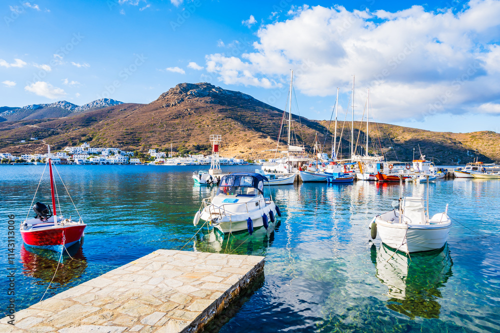 Boats anchoring in Katapola port with sea and mountains in background, Amorgos island, Cyclades, Greece