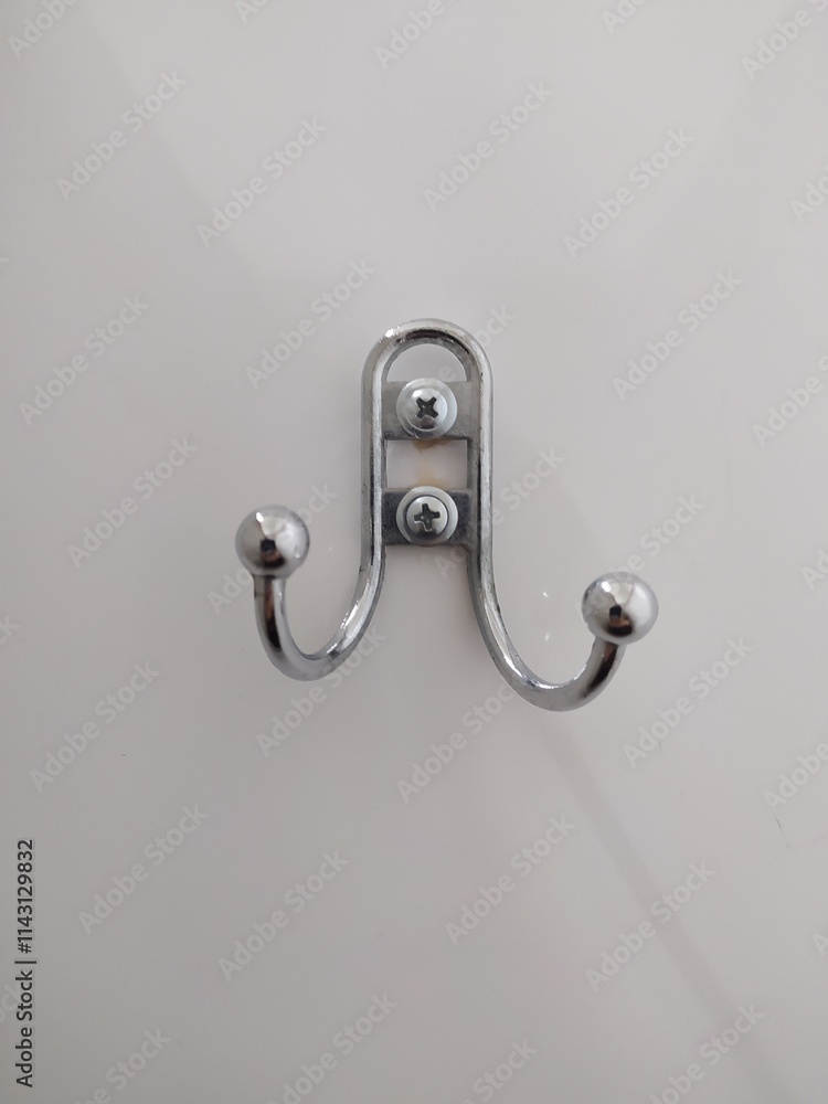 Coat or bag hook with two horns on white wall or door Coat or bag hook with two horns on white wall or door