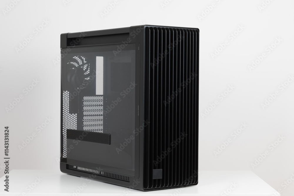 Obraz premium Side view of empty big tower, PC case, chassis, tempered-glass left panel has a mesh window to aid in graphics-card ventilation