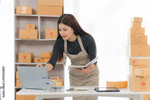 E-commerce Success:  A young woman, brimming with confidence, manages her online business with ease.  She's surrounded by stacks of cardboard boxes. photo