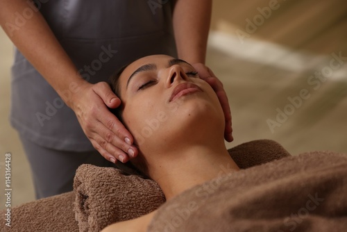 Young woman receiving massage in spa salon