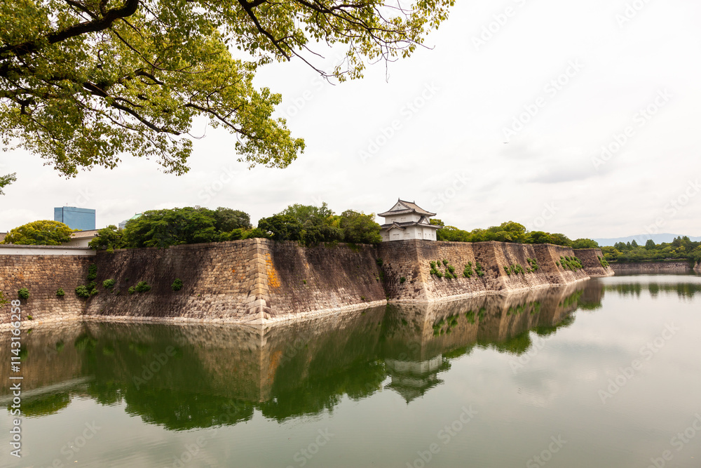 Historic Japanese Castle Moat with Reflections and Stone Walls Historic Japanese Castle Moat with Reflections and Stone Walls