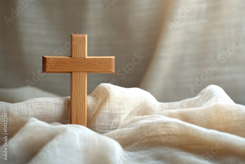 Simple wooden crucifix on fabric photo