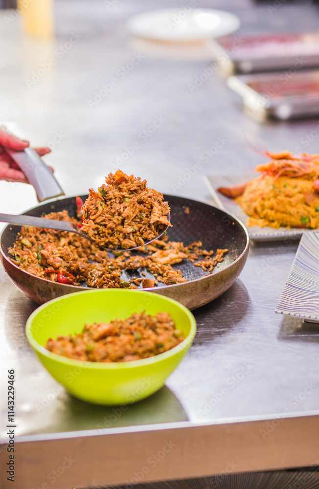 Chef preparing Chaulafan con marisco traditional ecuadorian dish in ecuadorian restaurant Chef preparing Chaulafan con marisco traditional ecuadorian dish in ecuadorian restaurant