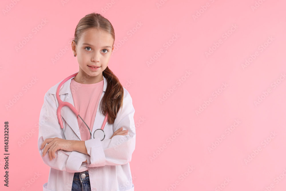 Girl with stethoscope pretending to be doctor on pink background, space for text. Dreaming of future profession Girl with stethoscope pretending to be doctor on pink background, space for text. Dreaming of future profession