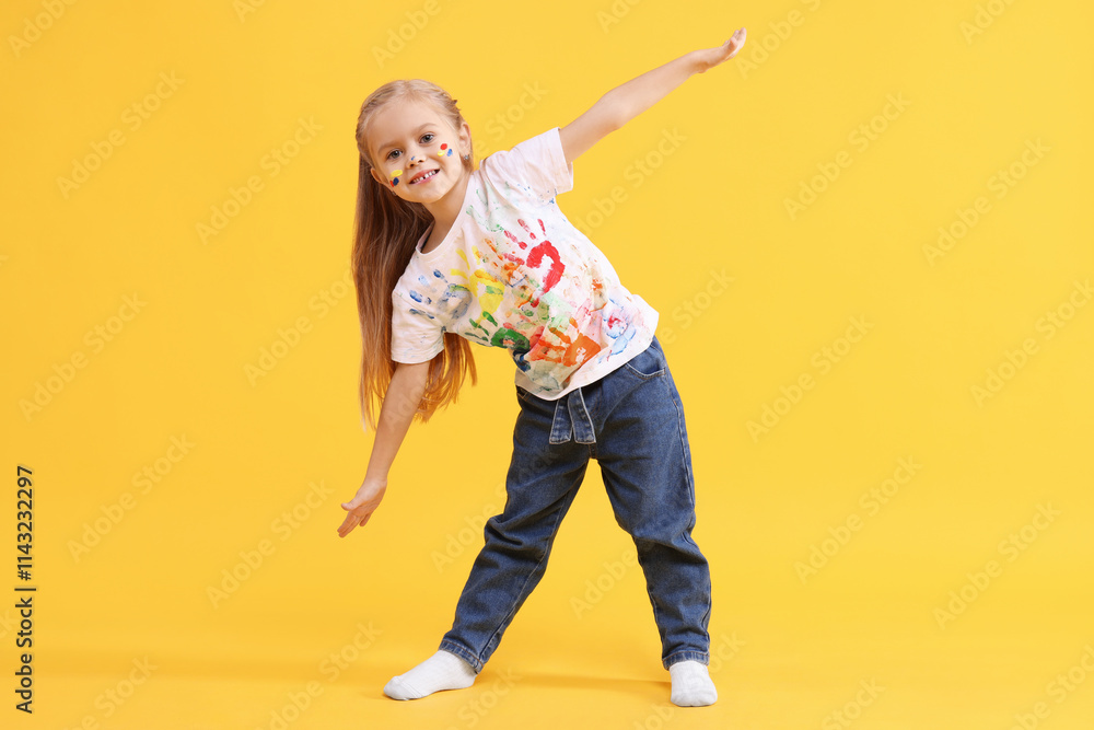 Smiling girl smeared in paint on orange background Smiling girl smeared in paint on orange background