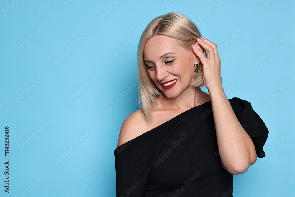 Smiling woman with perfect makeup on light blue background. Space for text