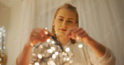 Home Preparations for Christmas Woman Untangles Lights and Arranges Decorations