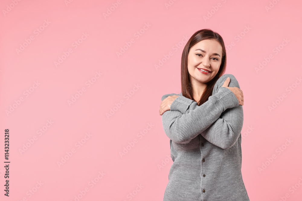 Beautiful young woman hugging herself on pink background, space for text Beautiful young woman hugging herself on pink background, space for text