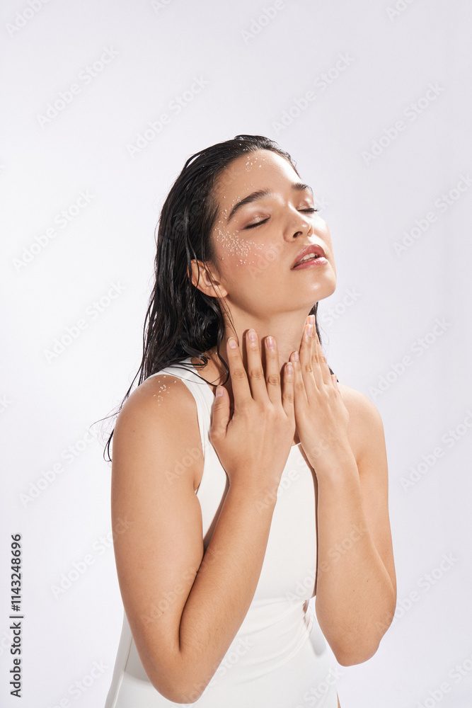 Female model enjoying a refreshing moment in studio Female model enjoying a refreshing moment in studio