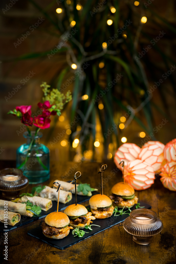 Elegant party table with sliders, rolls, flowers and candles Elegant party table with sliders, rolls, flowers and candles