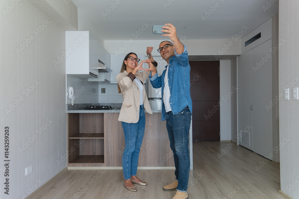 A man and woman are standing in a kitchen, taking a selfie. New home concept. A man and woman are standing in a kitchen, taking a selfie. New home concept.