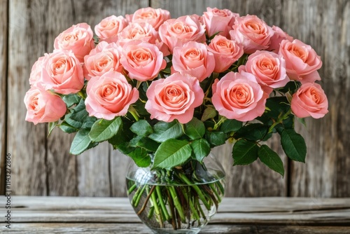 Pink Roses in Elegant Glass Vase on Rustic Wooden Background