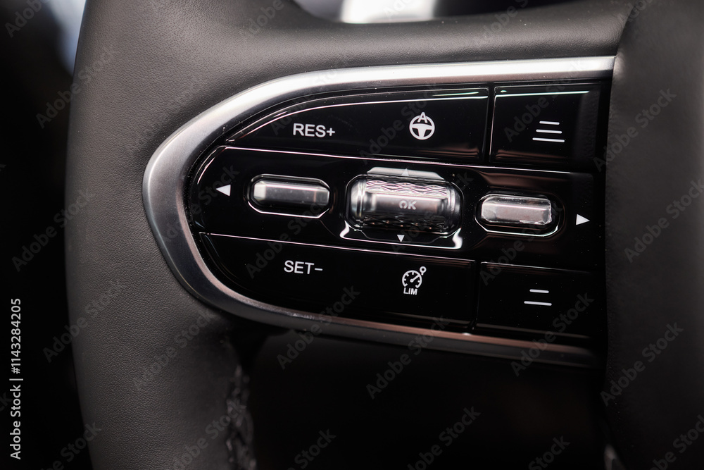 Fototapeta premium The modern cars steering wheel control panel boosts convenience and performance
