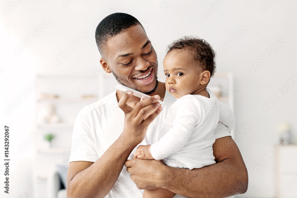 Modern Technologies And Babies. Black Father Holding Infant Child And Talking On Speakerphone At Home, Happy Young African American Man Joining Little Kid To Mobile Conversation, Free Space Modern Technologies And Babies. Black Father Holding Infant Child And Talking On Speakerphone At Home, Happy Young African American Man Joining Little Kid To Mobile Conversation, Free Space