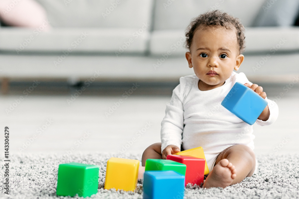 Portrait Of Adorable Black Infant Baby Playing With Stacking Building Blocks At Home, Cute Little African American Child Sitting On Carpet With Toys In Living Room And Looking At Camera, Copy Space Portrait Of Adorable Black Infant Baby Playing With Stacking Building Blocks At Home, Cute Little African American Child Sitting On Carpet With Toys In Living Room And Looking At Camera, Copy Space