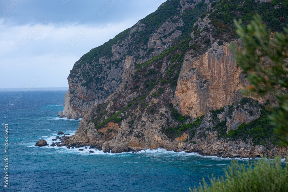 A lonely little rocky island in the open sea. Storm at sea, raging waves crashing against the little island and exploding with white spray. Rock in a stormy sea A lonely little rocky island in the open sea. Storm at sea, raging waves crashing against the little island and exploding with white spray. Rock in a stormy sea
