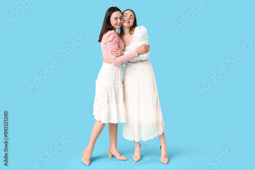 Two happy young women embra...