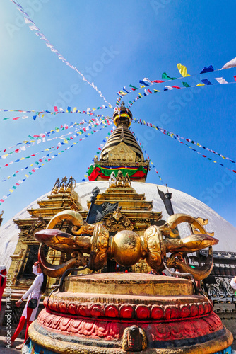 A giant vajra, sacred buddhist religious symbol of strength and enlightenment in front of the Swayambhunath Mahachaitya, a center of Newar Buddhism in Kathmandu,Nepal  photo