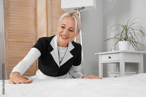 Middle-aged chambermaid mak...