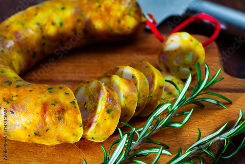 Spanish sausage butifarra on a wooden table, closeup photo