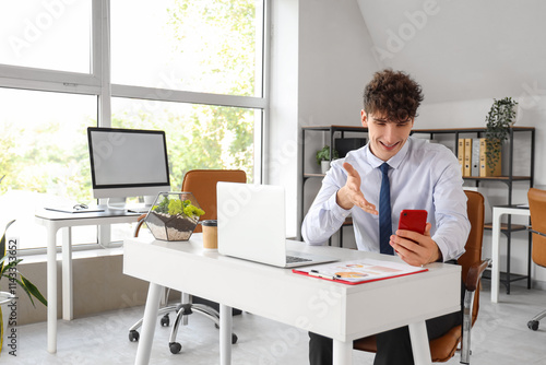 Young businessman with mobi...