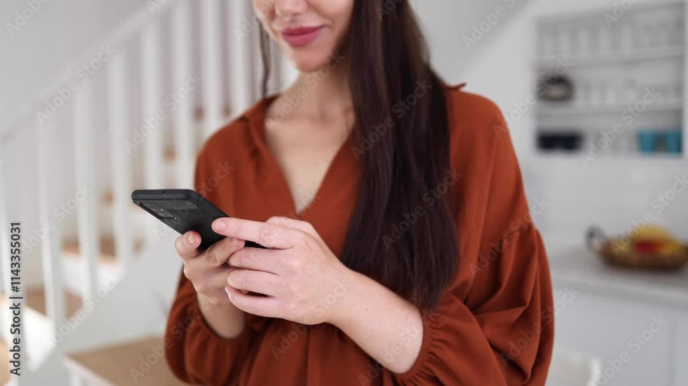Beautiful, young woman enjoying at home and using her smartphone Beautiful, young woman enjoying at home and using her smartphone