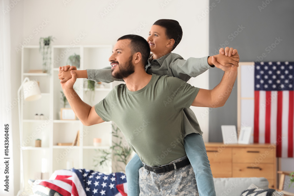 Happy little boy with his military father at home. Veterans Day celebration Happy little boy with his military father at home. Veterans Day celebration