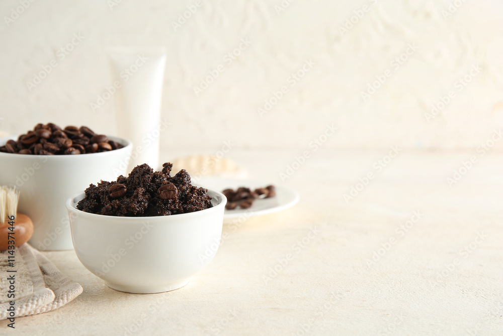 Composition with bowls of coffee body scrub and coffee beans on light grunge background Composition with bowls of coffee body scrub and coffee beans on light grunge background