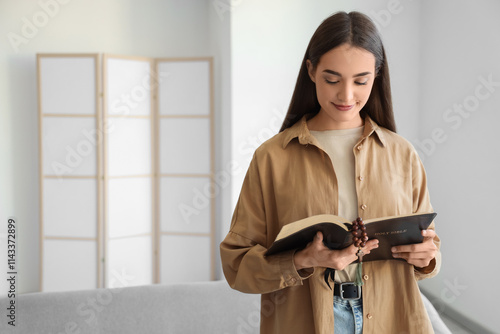 Young woman reading Holy Bi...