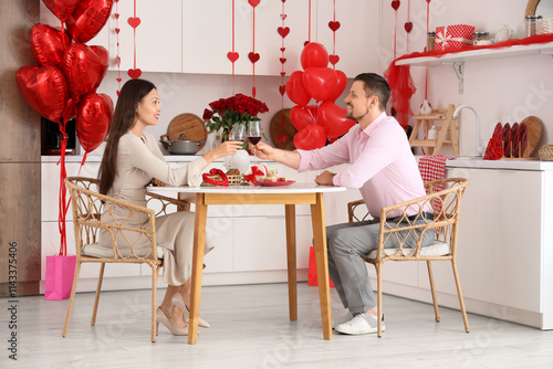 Young couple with wine sitt...