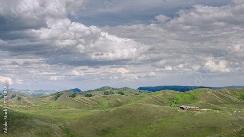 Vast summer landscape of Daqingshan Mountains featuring rolling hills and dramatic clouds in Inner Mongolia photo