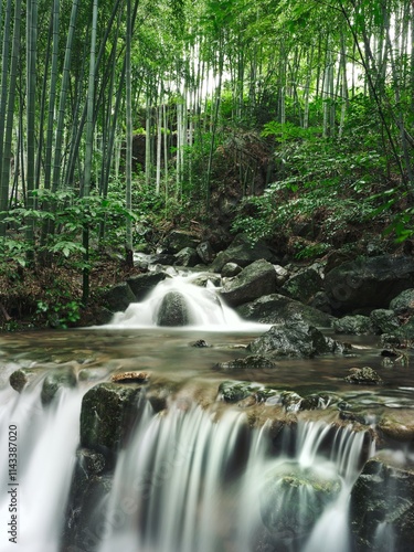 Bamboo waterfall flows gently through Anji mountains during the rainy season photo