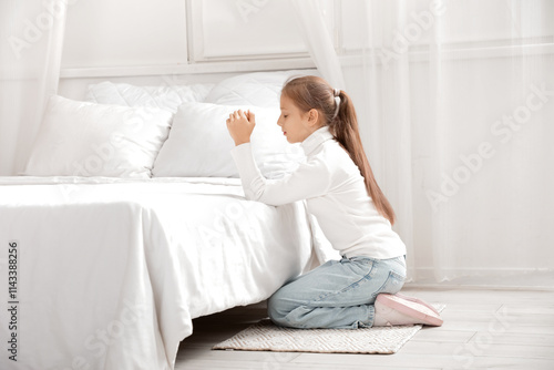 Teenage girl praying near b...