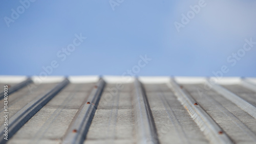 Close up of corrugated iron roofing material against blue sky photo