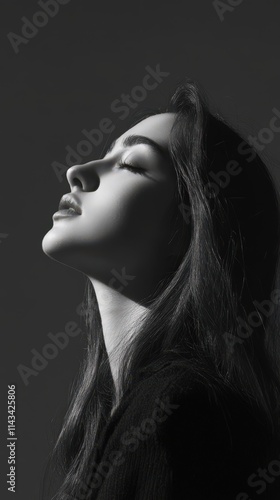 A monochromatic close-up profile of a young woman with eyes closed, conveying calmness and introspection. The smooth lighting enhances her facial features, offering a soft, elegant aesthetic. AI