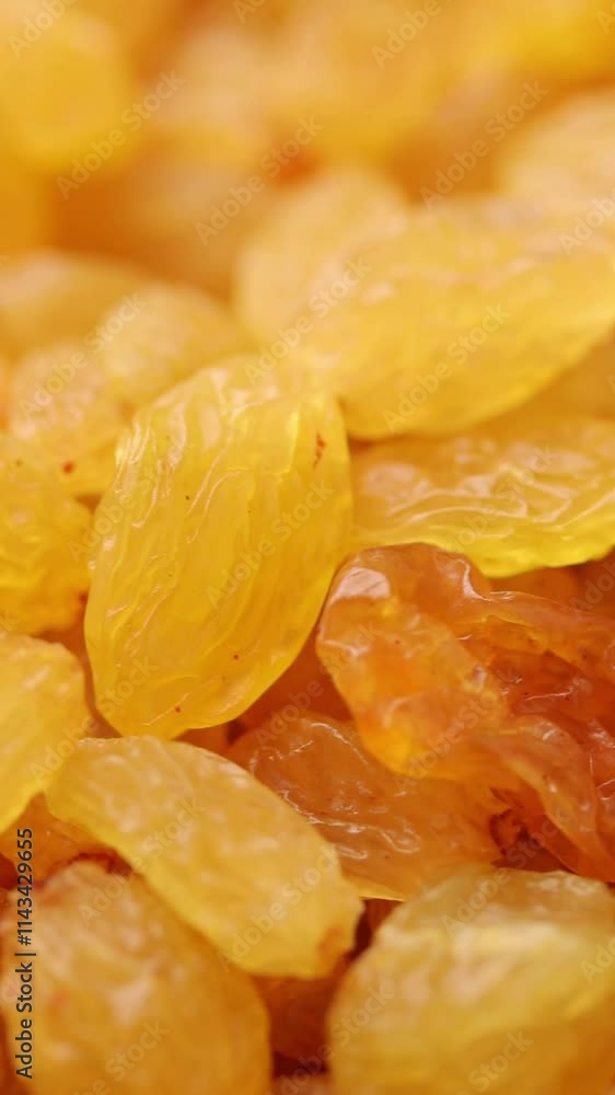 Heap of yellow raisins rotation. Close-up shot Heap of yellow raisins rotation. Close-up shot
