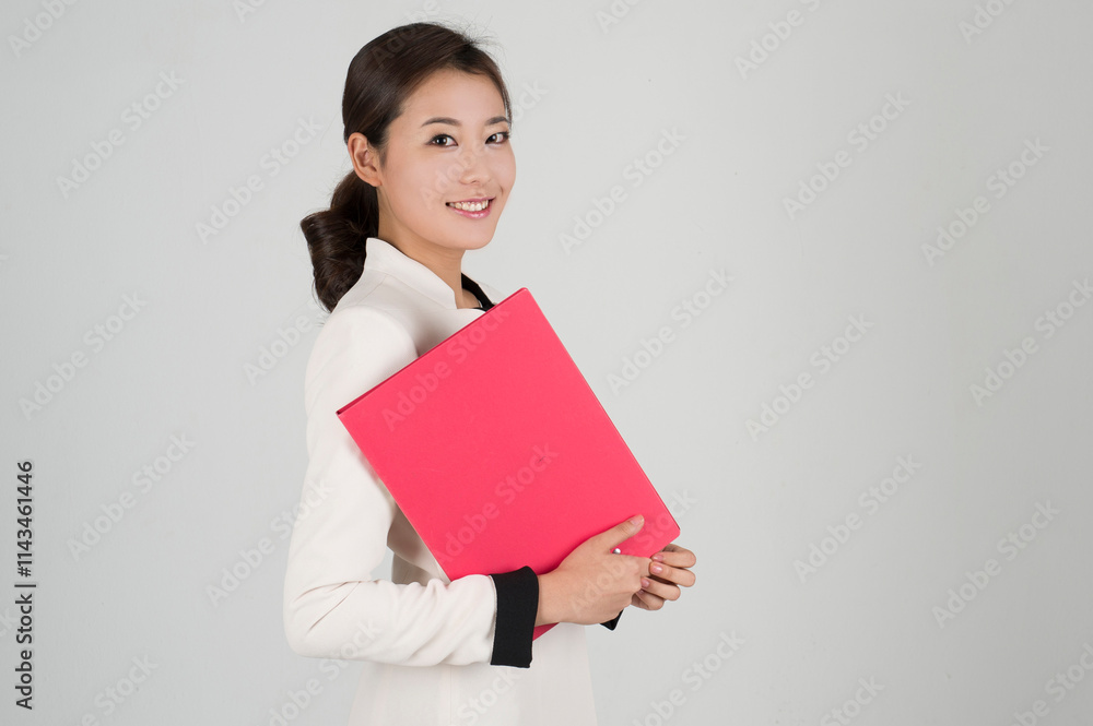 Asian young business woman in a suit posing with a smile and cheering Asian young business woman in a suit posing with a smile and cheering