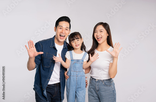 portrait  of a happy asian  family posing on a white background photo