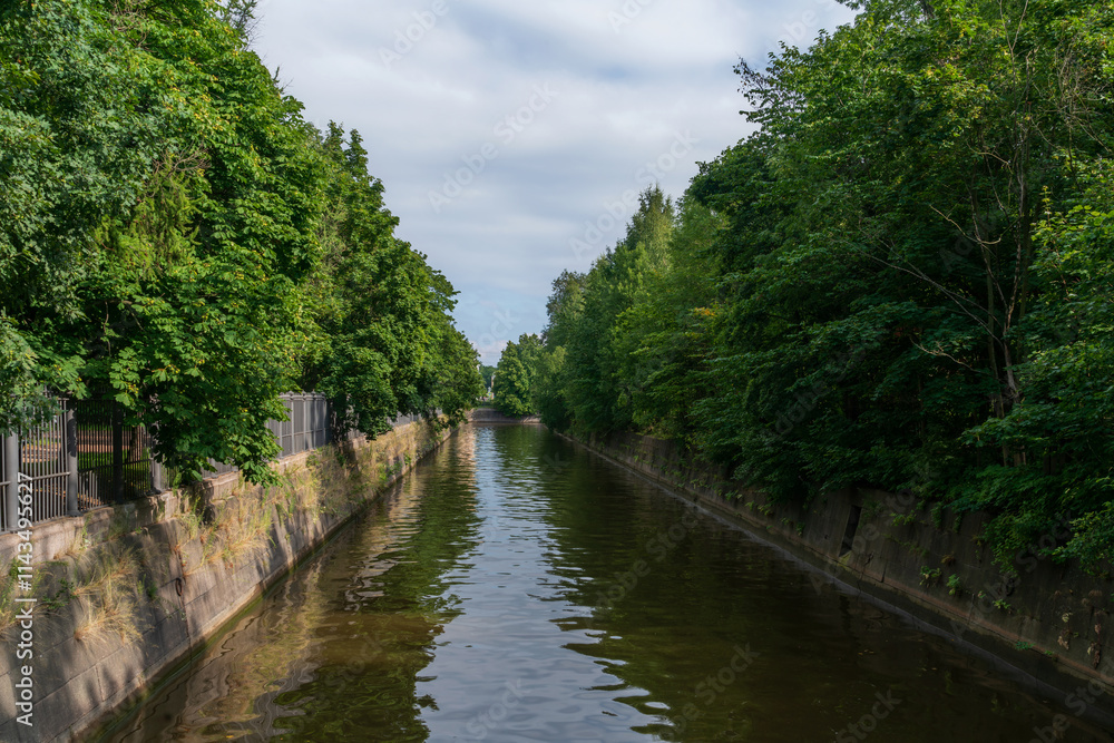 View of the Obvodny (Admiralteysky, Wired) Canal along Sovetskaya Street on a sunny summer day, Kronstadt, St. Petersburg, Russia View of the Obvodny (Admiralteysky, Wired) Canal along Sovetskaya Street on a sunny summer day, Kronstadt, St. Petersburg, Russia