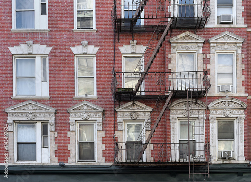 Photography New York City, old apartment building with external fire ladder and ornamental c