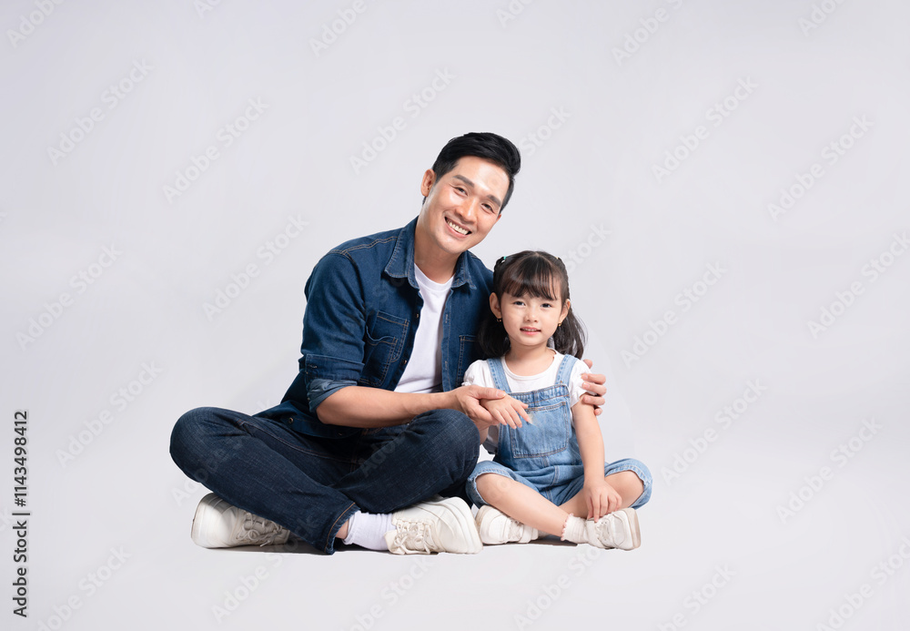 Full body image of Asian father and daughter posing on white background Full body image of Asian father and daughter posing on white background
