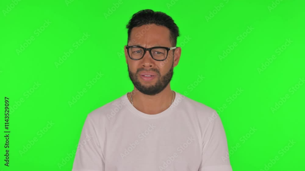 Man Reacting to Failure on Green Background Man Reacting to Failure on Green Background