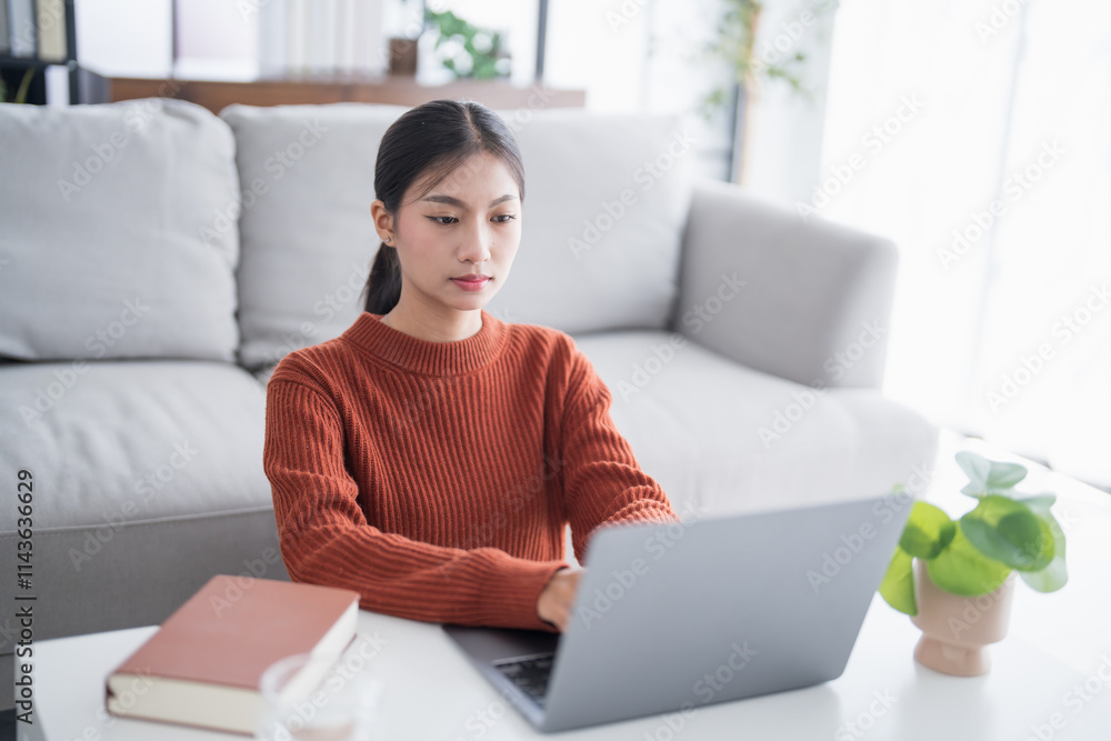 Business woman working from home. work online on laptop. Asian businesswoman working on sofa online business with social distancing laptop online meeting Business woman working from home. work online on laptop. Asian businesswoman working on sofa online business with social distancing laptop online meeting