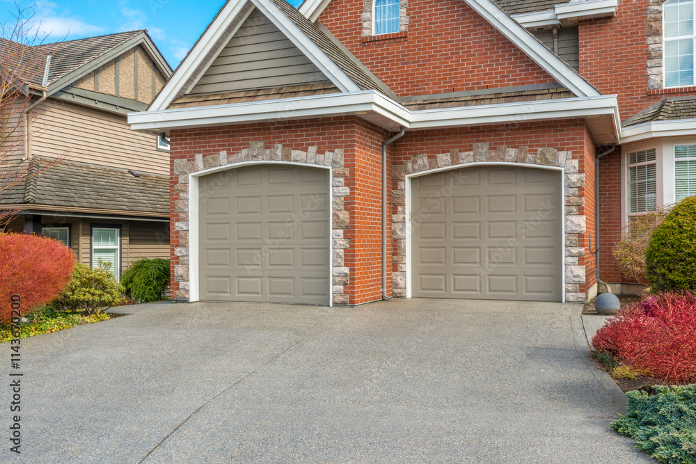 Garage door in luxury house with trees and nice landscape in Summer in Vancouver, Canada, North America. Day time on June 2024. Garage door in luxury house with trees and nice landscape in Summer in Vancouver, Canada, North America. Day time on June 2024.