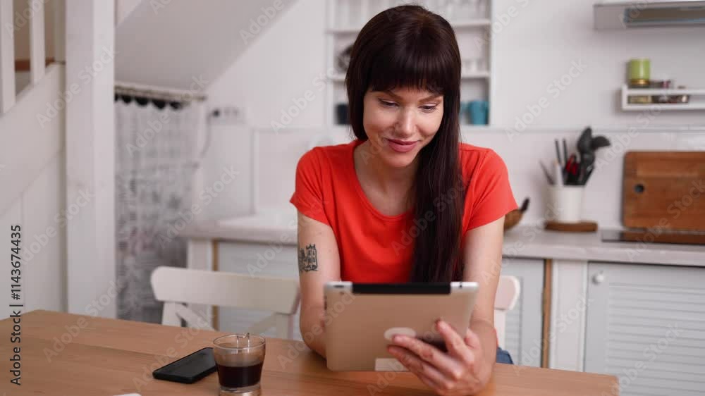 Beautiful, young woman enjoying at home and using her digital tablet Beautiful, young woman enjoying at home and using her digital tablet