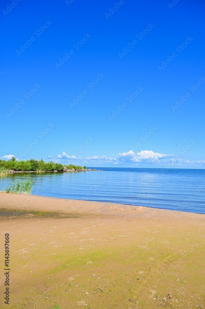Summer view over the sandy beach to Lake Peipus (Peipsi-Pihkva järv) under a blue sky in summer near Kallaste, Tartu, Estonia Summer view over the sandy beach to Lake Peipus (Peipsi-Pihkva järv) under a blue sky in summer near Kallaste, Tartu, Estonia