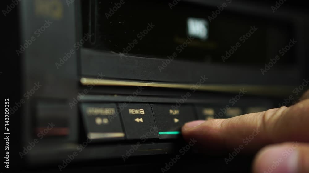 Loading VHS Cassette Tape and Pressing Plat on VCR, Close Up Selective Focus Loading VHS Cassette Tape and Pressing Plat on VCR, Close Up Selective Focus